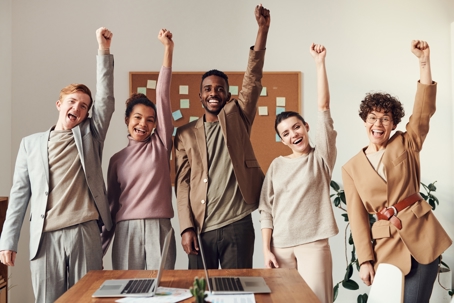 Entrepreneurs putting their left arms up in celebration