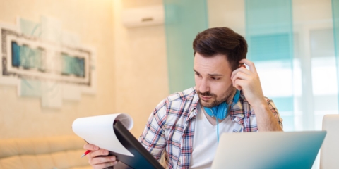 guy looking at paperwork