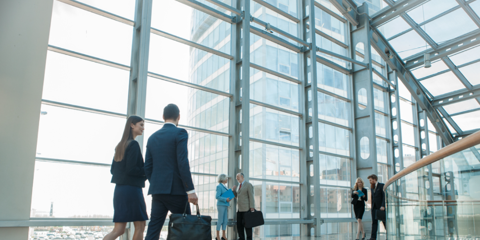 people walking in glass building