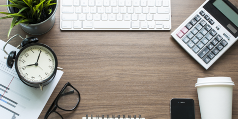 desk with computer and clock