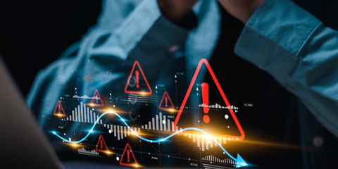 Businessman use laptop with virtual world economic growth chart with red warning sign for caution in investing economic situation warning, Business investment risks.