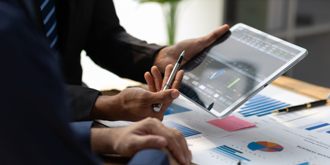 Businessman meeting with consultants discussing data analysis, charts and graphs in financial reports to plan investments and increase company profits.