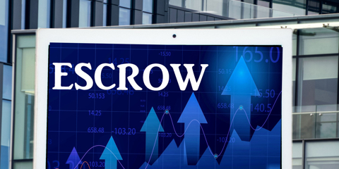 a digital display tablet with the word escrow and modern office building in the background