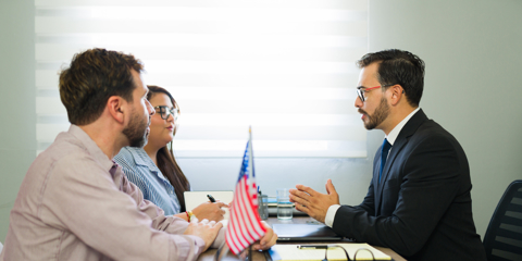 Serious applicants consulting with attorney about immigration law, receiving professional legal advice and guidance for their futu