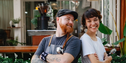 Two people standing together smiling