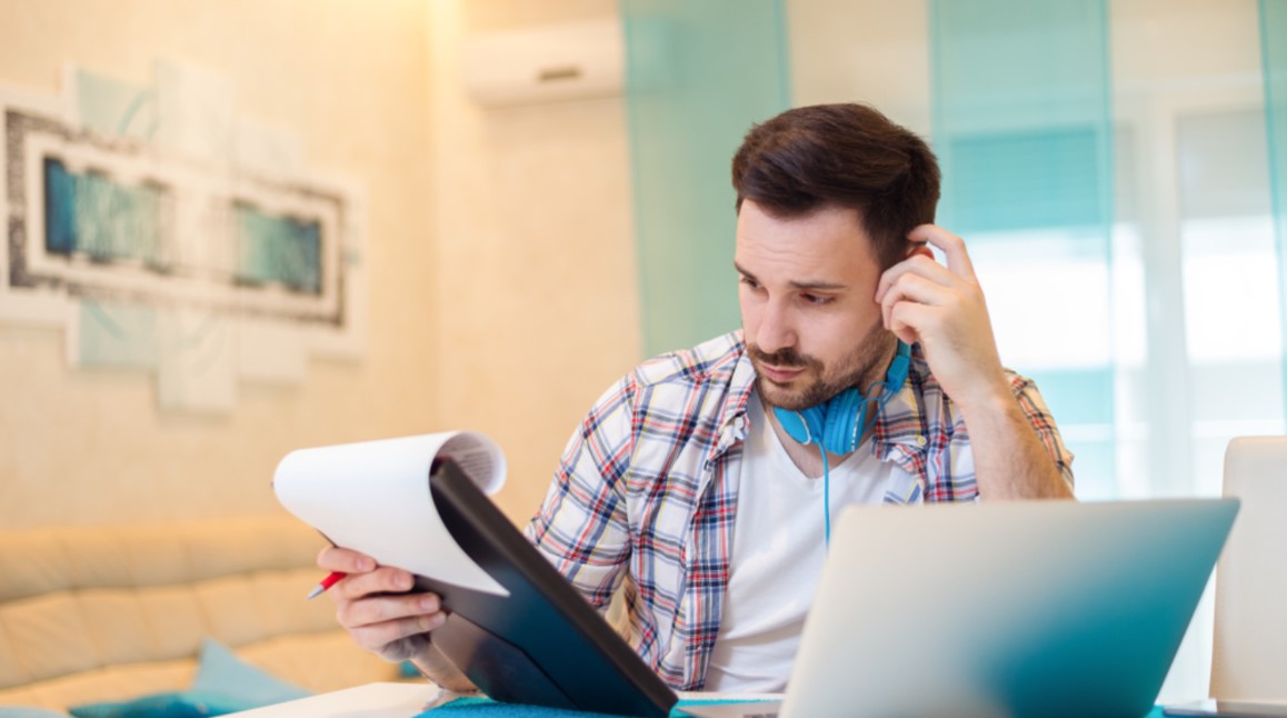 guy looking at paperwork