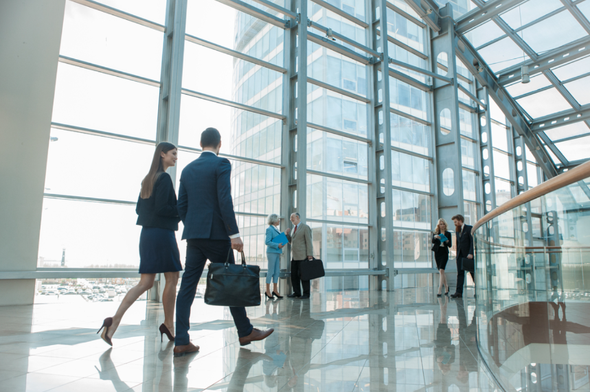 people walking in glass building