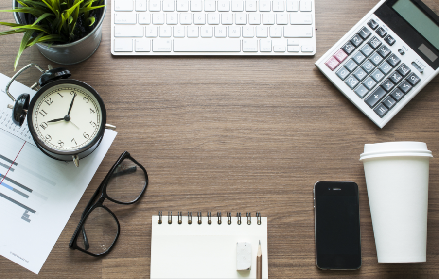desk with computer and clock