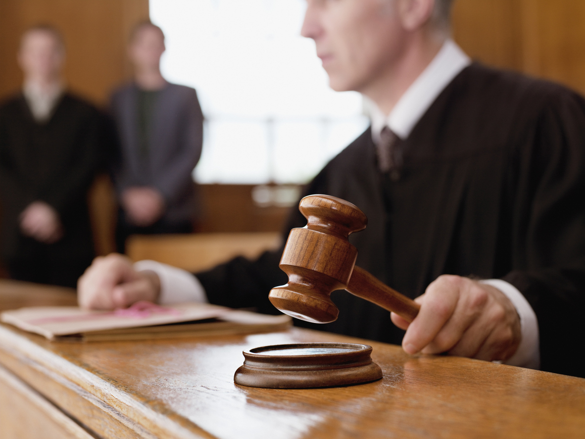 Description Judge holding gavel in courtroom