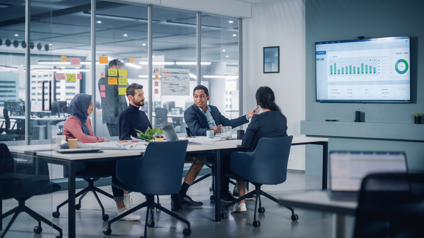 Multi-Ethnic Office Conference Room Meeting: Diverse Team of Successful Managers, Executives Talk, Use Green Screen Chroma Key TV. Businesspeople Investing in Growing e-Commerce Startup.