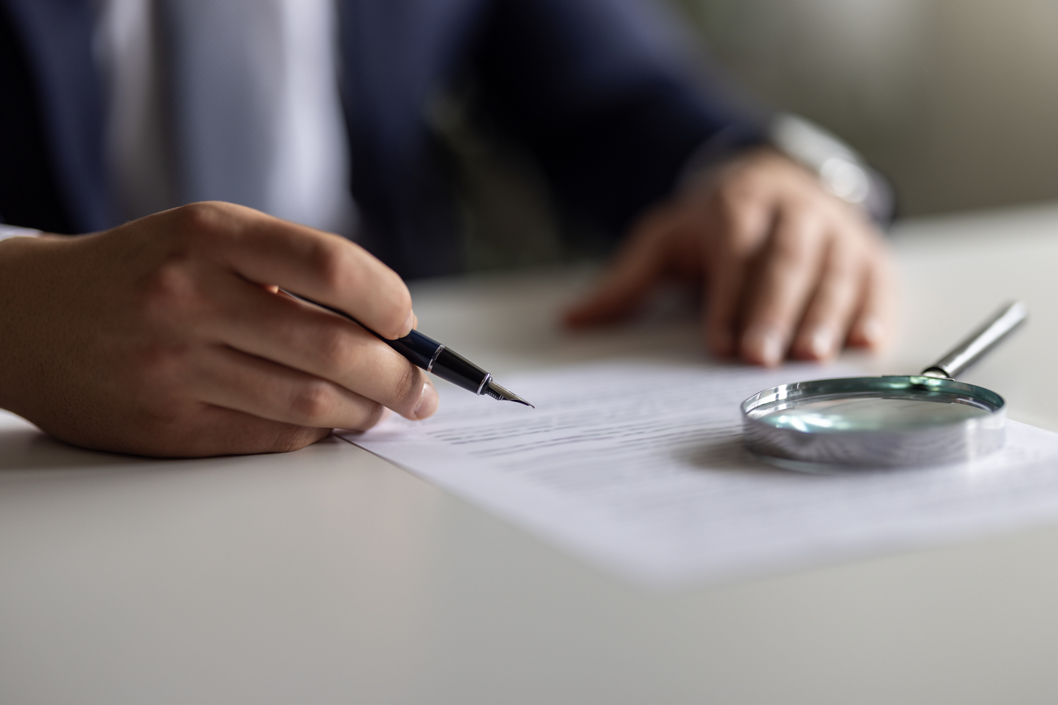 Businessman Reading Contract Details Before Signing