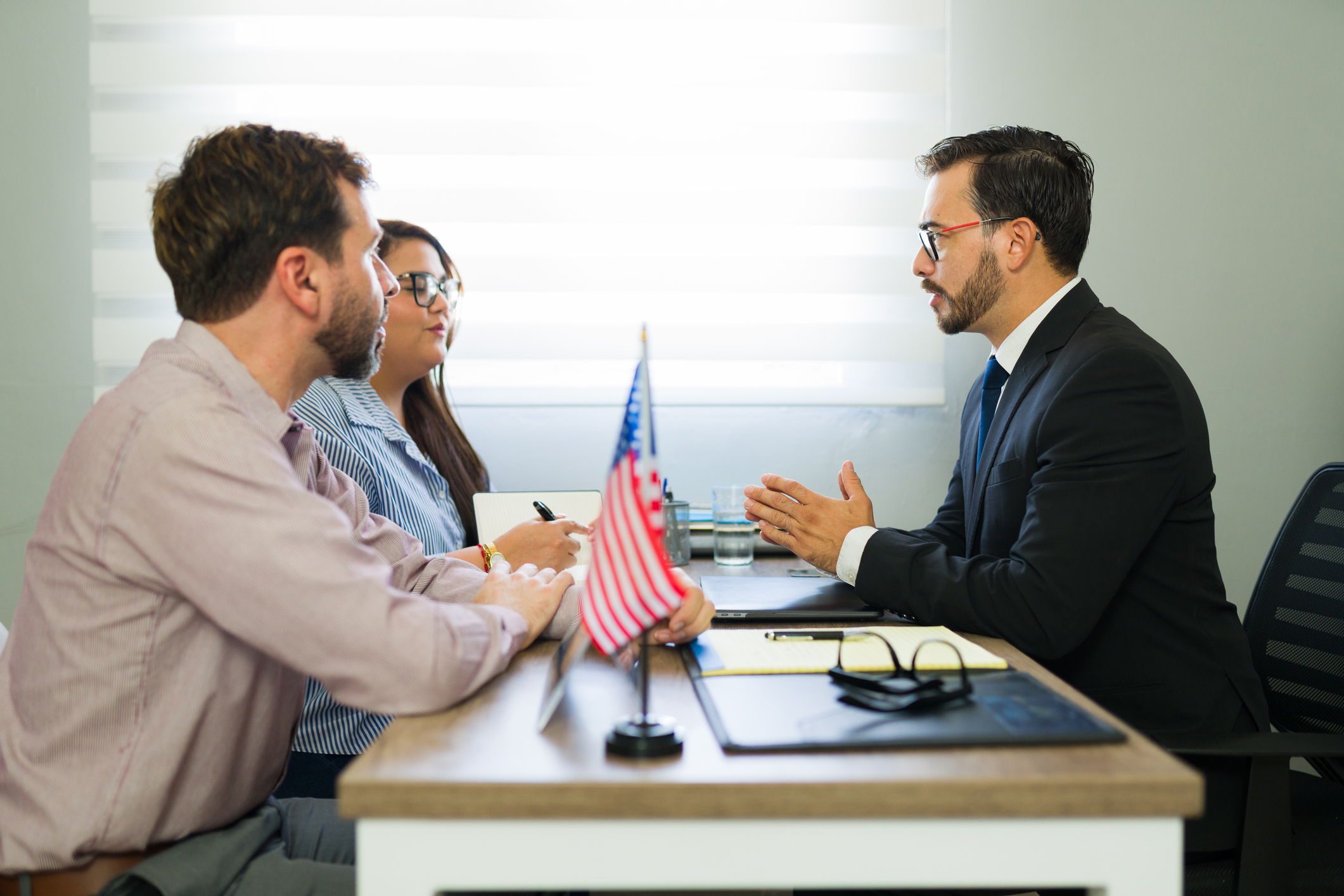 Serious applicants consulting with attorney about immigration law, receiving professional legal advice and guidance for their futu